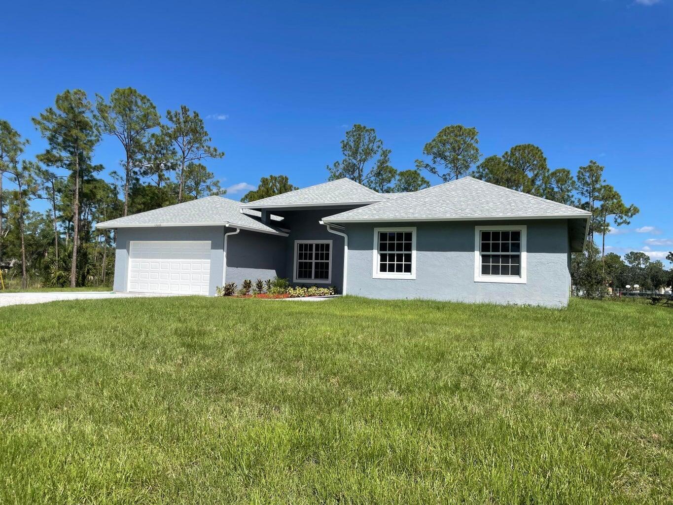 17225 78th Road North Loxahatchee, FL 33470 - Photo 2 of 93 a front view of a house with a yard