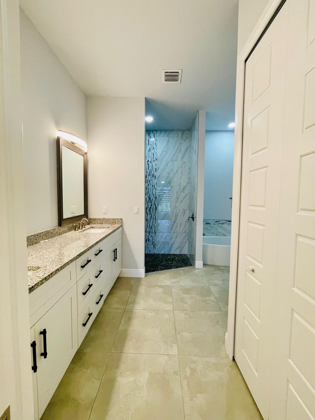17225 78th Road North Loxahatchee, FL 33470 - Photo 23 of 93 a bathroom with a granite countertop sink a mirror and shower