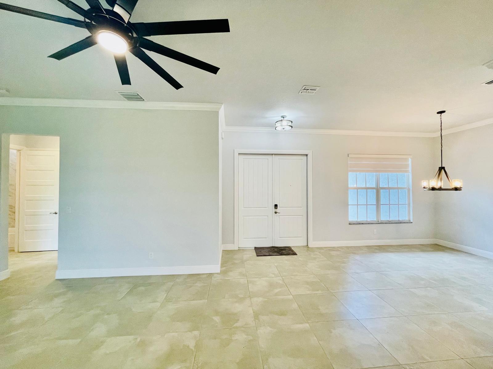 17225 78th Road North Loxahatchee, FL 33470 - Photo 49 of 93 an empty room with ceiling fan and window