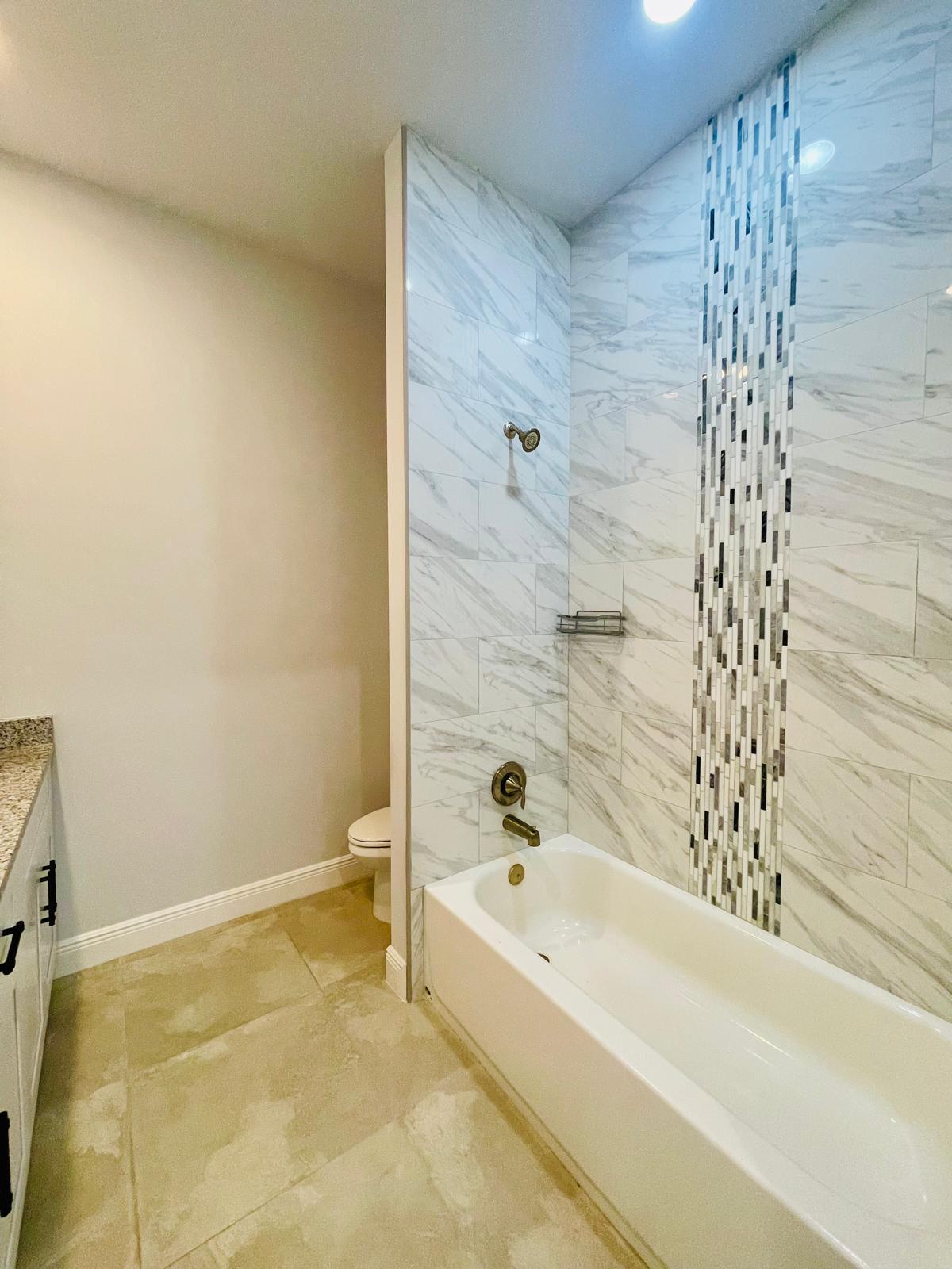 17225 78th Road North Loxahatchee, FL 33470 - Photo 53 of 93 a bathroom with a bathtub and shower