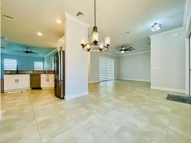 a kitchen with stainless steel appliances granite countertop a refrigerator sink and cabinets