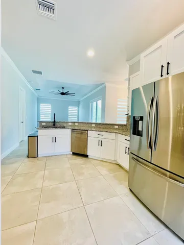 a large kitchen with cabinets and stainless steel appliances