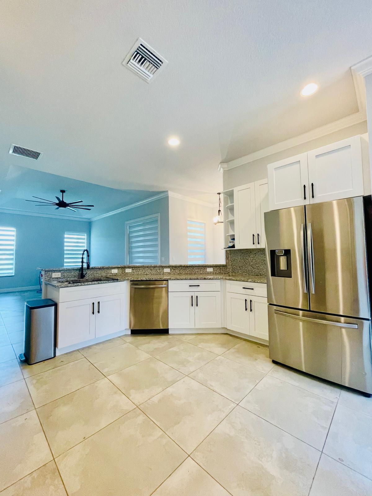 17225 78th Road North Loxahatchee, FL 33470 - Photo 10 of 93 a kitchen with stainless steel appliances a refrigerator sink and microwave