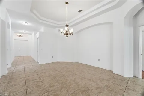 a view of a chandelier in big room and chandelier