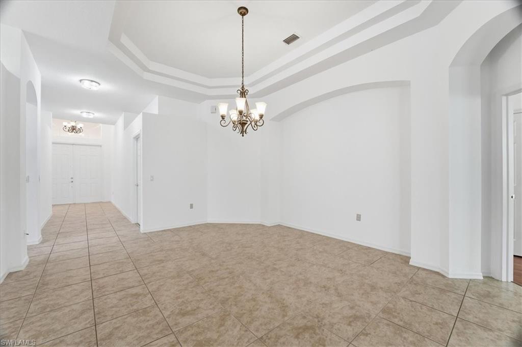 14439 Manchester Drive Naples, FL 34114 - Photo 1 of 47 a view of a chandelier in big room and chandelier