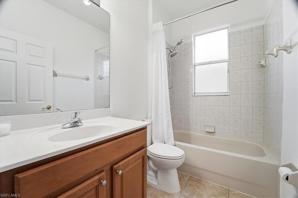 14439 Manchester Drive Naples, FL 34114 - Photo 13 of 47 a bathroom with a sink a toilet and shower