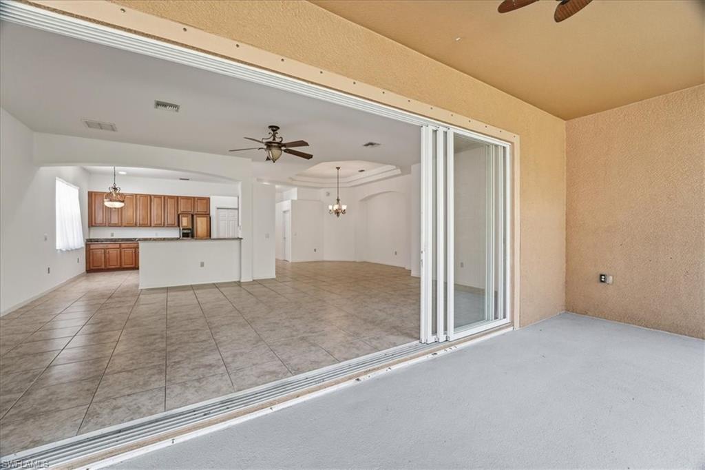 14439 Manchester Drive Naples, FL 34114 - Photo 15 of 47 a view of a hallway with wooden floor and cabinet