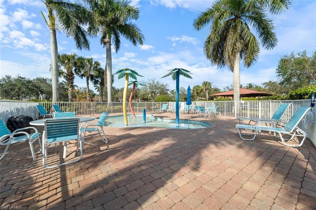14439 Manchester Drive Naples, FL 34114 - Photo 25 of 47 a view of a swimming pool with a table and chairs