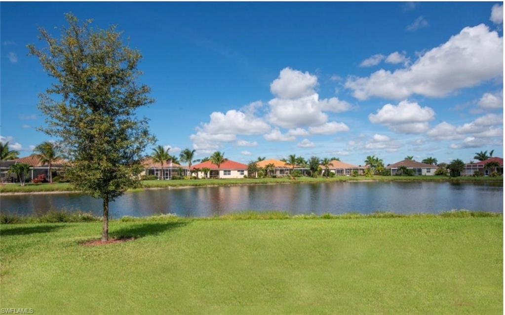 14439 Manchester Drive Naples, FL 34114 - Photo 29 of 47 a view of a lake with houses in the background