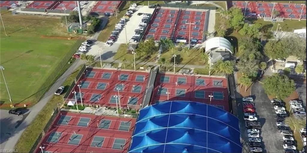 14439 Manchester Drive Naples, FL 34114 - Photo 36 of 47 a aerial view of a brick building next to a yard
