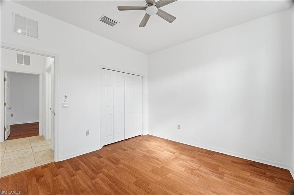 14439 Manchester Drive Naples, FL 34114 - Photo 10 of 47 wooden floor in an empty room