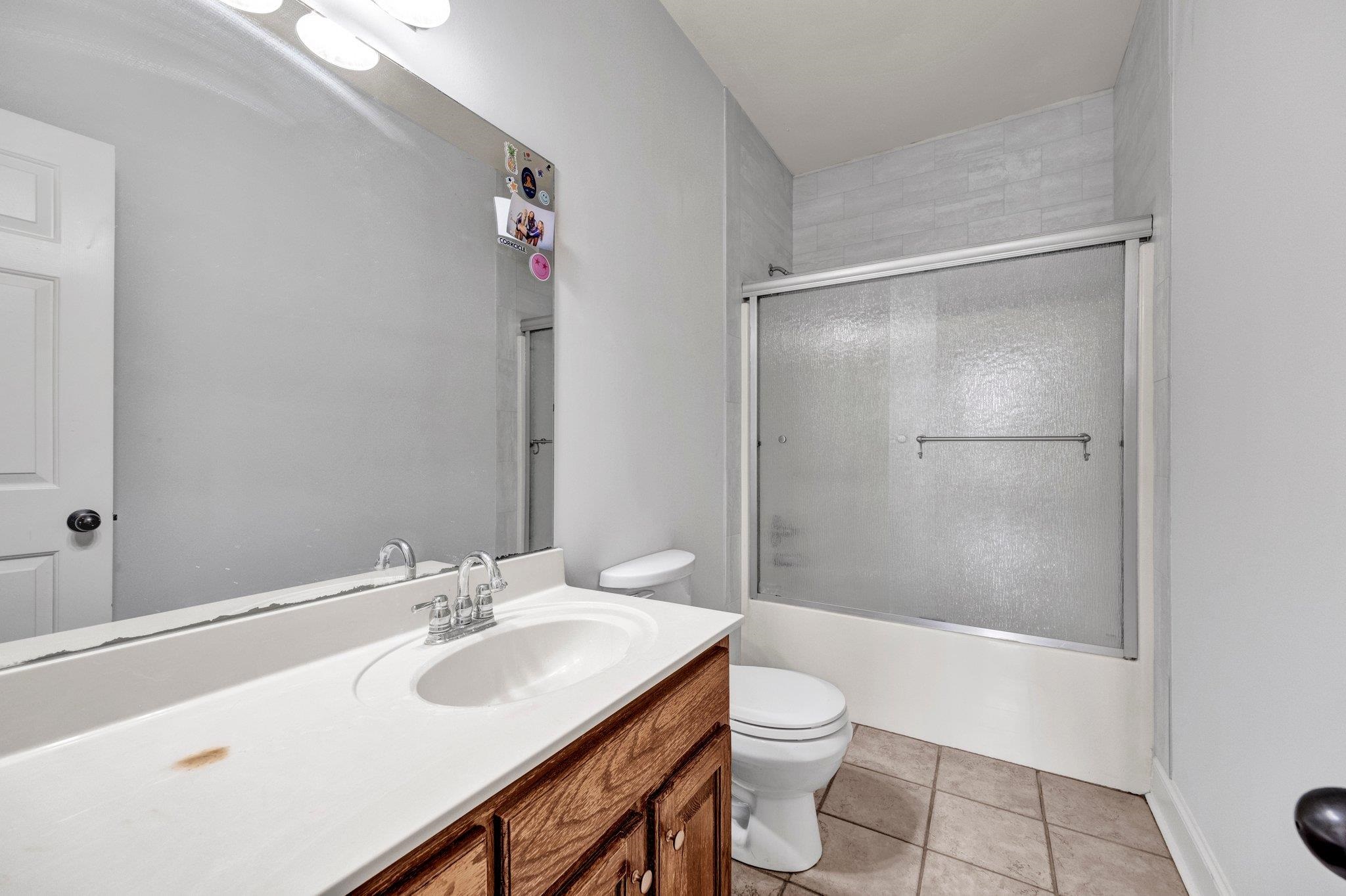 914 Beaver Creek Road Brighton, TN 38011 - Photo 13 of 39 a bathroom with a sink toilet vanity and shower