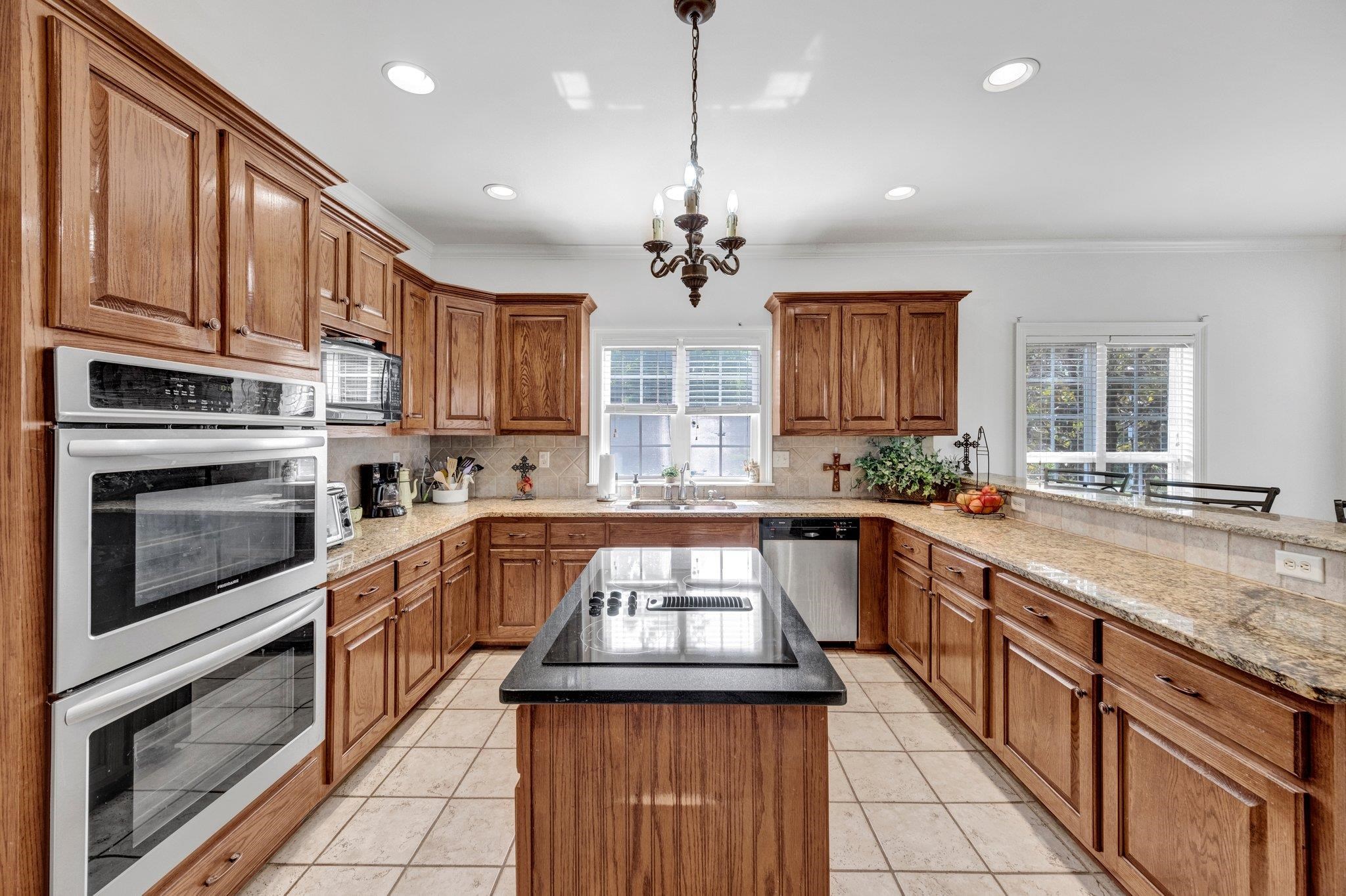 914 Beaver Creek Road Brighton, TN 38011 - Photo 15 of 39 a kitchen with stainless steel appliances granite countertop a stove sink microwave and cabinets