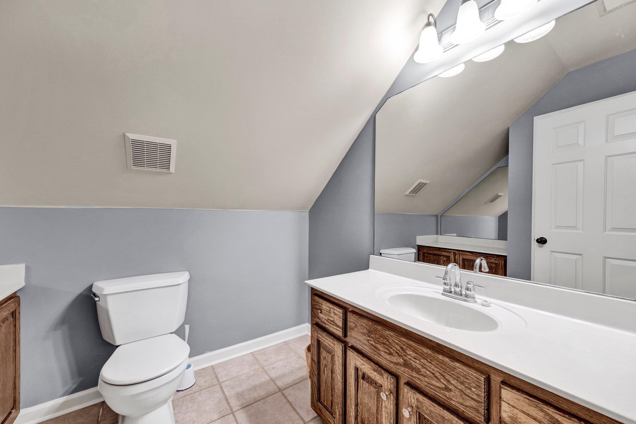 914 Beaver Creek Road Brighton, TN 38011 - Photo 22 of 39 a bathroom with a toilet sink and mirror