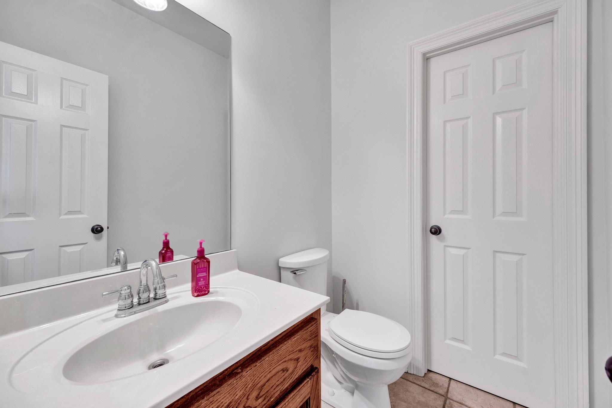 914 Beaver Creek Road Brighton, TN 38011 - Photo 24 of 39 a bathroom with a sink toilet and a mirror