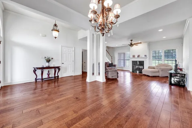 a view of a livingroom with furniture a table and wooden floor