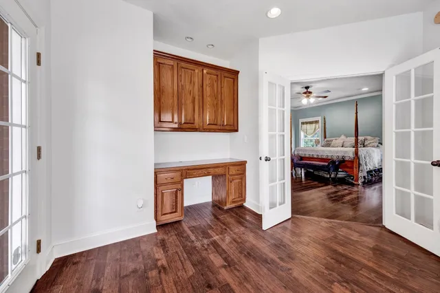 a bed sitting in a bedroom next to a window