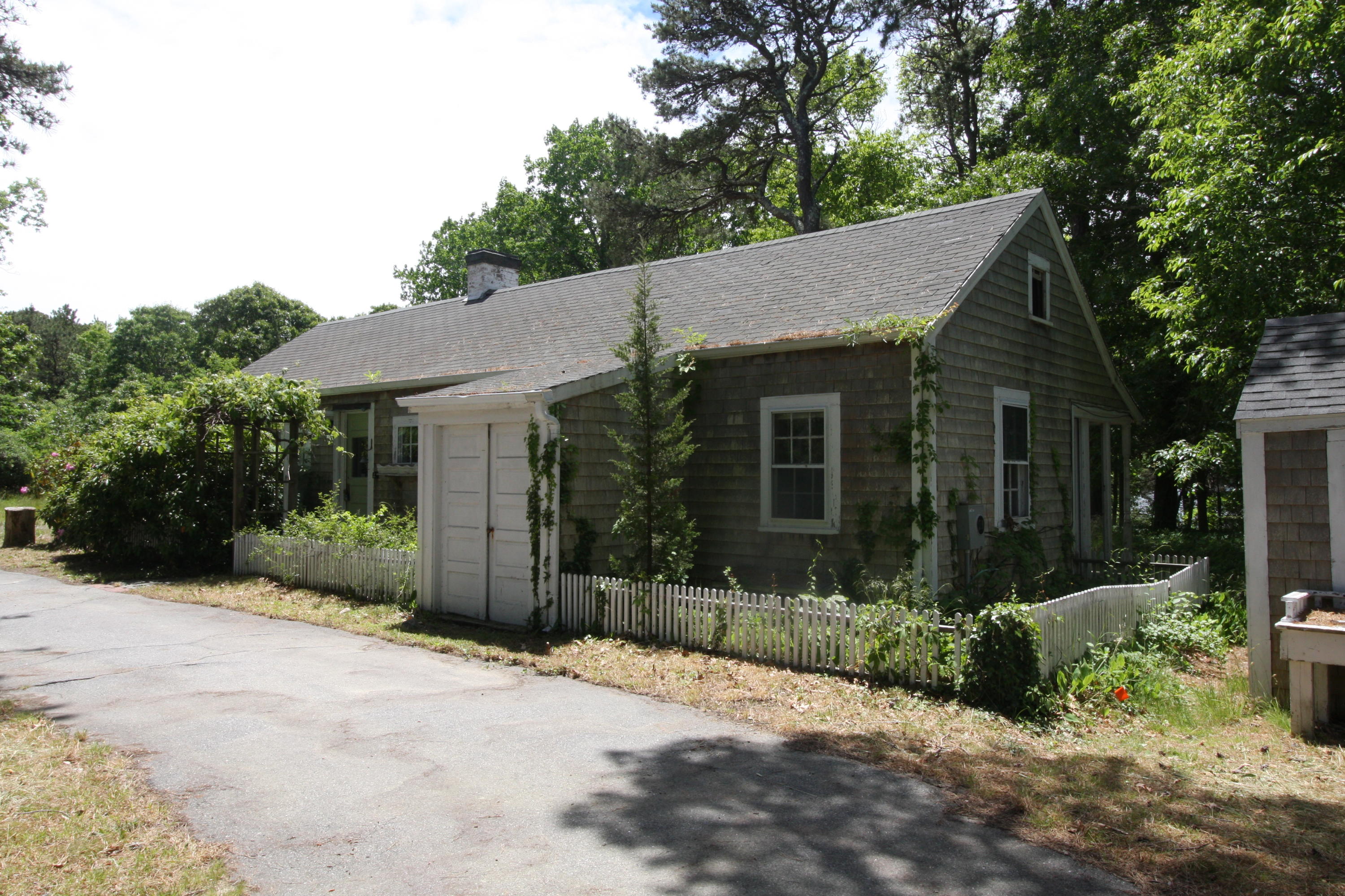 51 Paddocks Path Dennis, MA 02638 - Photo 14 of 22 a front view of a house with a yard and potted plants