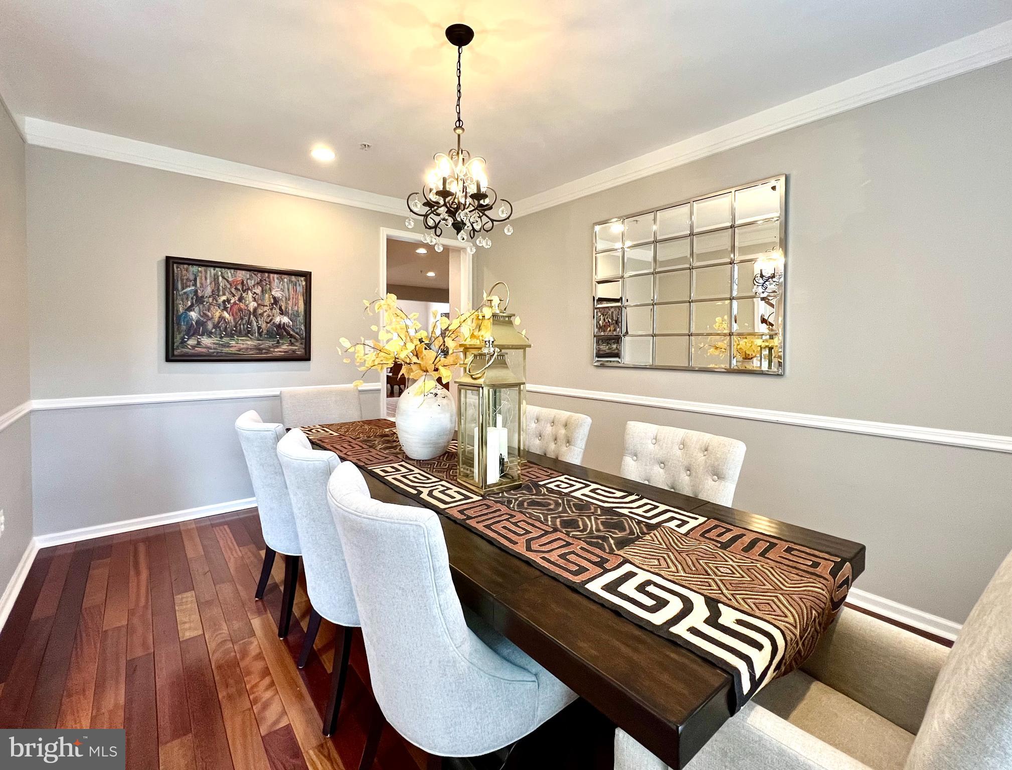13501 Oaklands Manor Drive Laurel, MD 20708 - Photo 14 of 46 a view of a dining room with furniture a chandelier and wooden floor