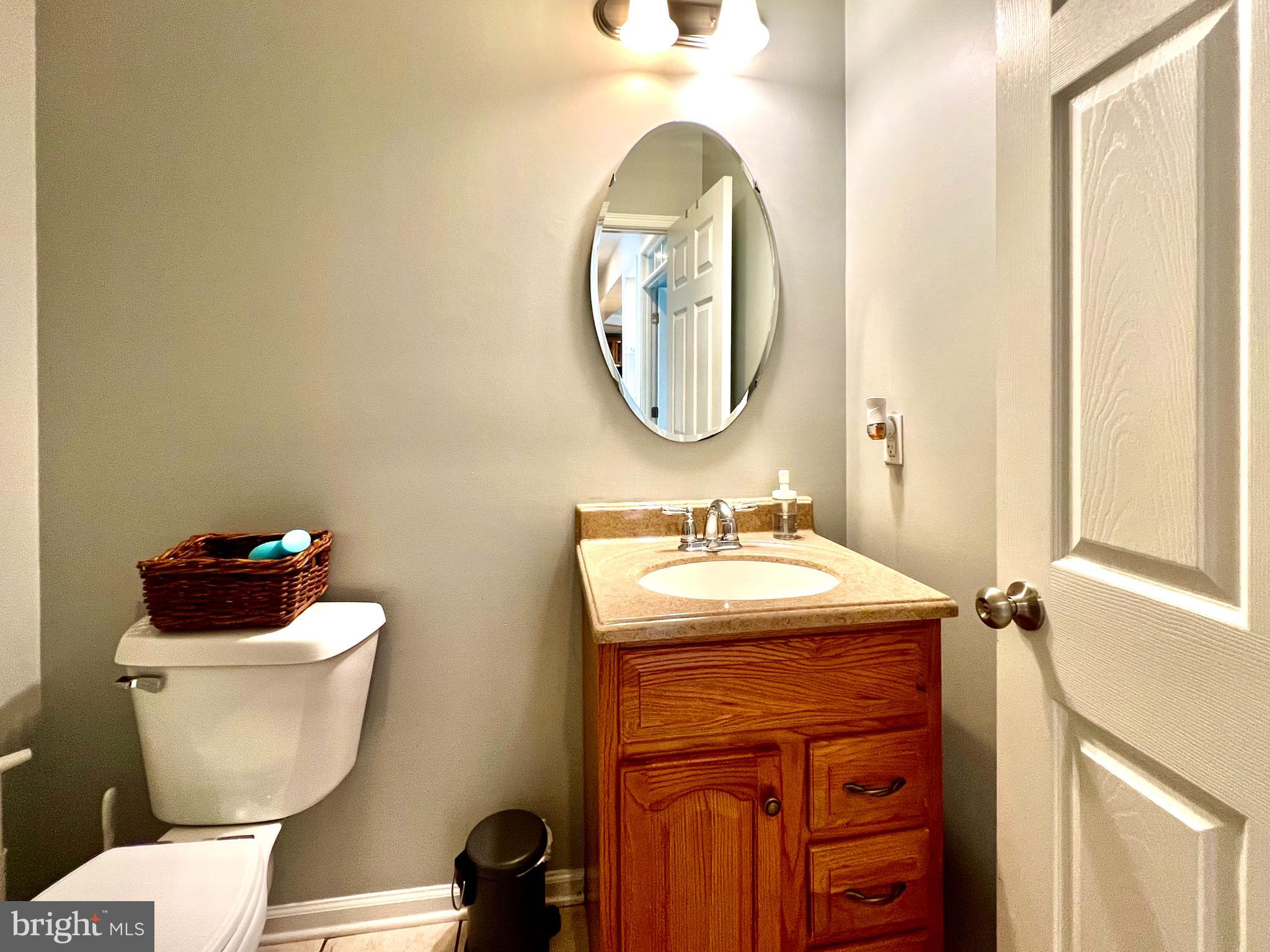 13501 Oaklands Manor Drive Laurel, MD 20708 - Photo 15 of 46 a bathroom with a toilet sink and mirror