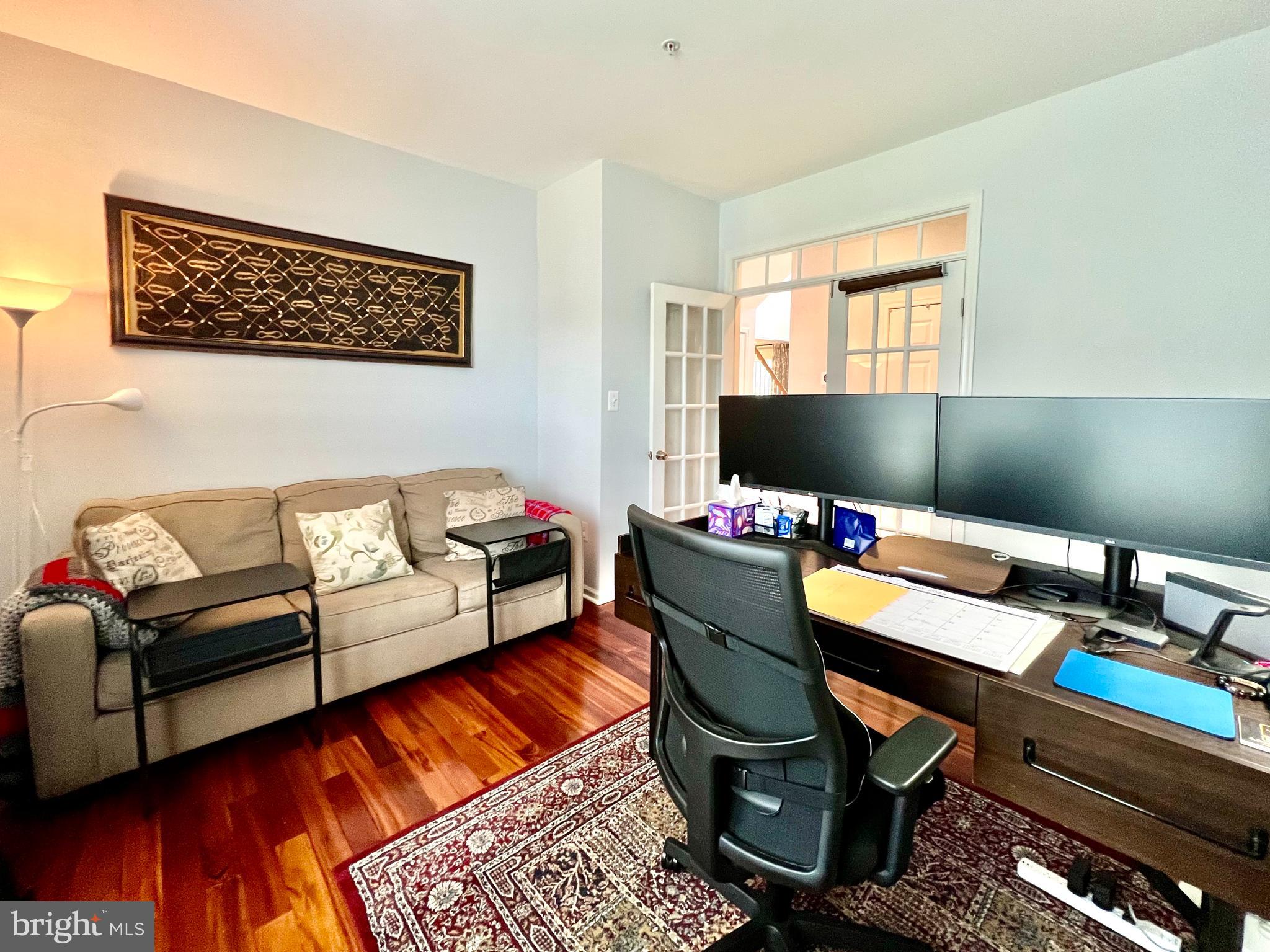 13501 Oaklands Manor Drive Laurel, MD 20708 - Photo 16 of 46 a workspace with furniture and wooden floor