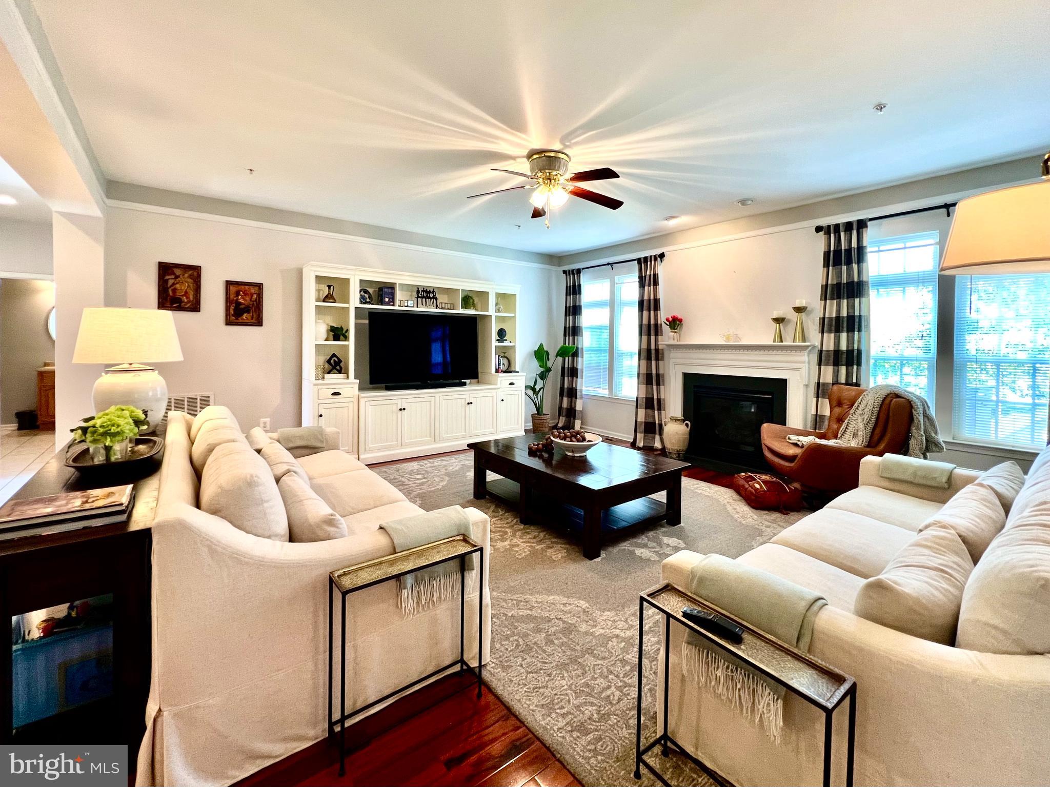 13501 Oaklands Manor Drive Laurel, MD 20708 - Photo 17 of 46 a living room with furniture flat screen tv and a fireplace
