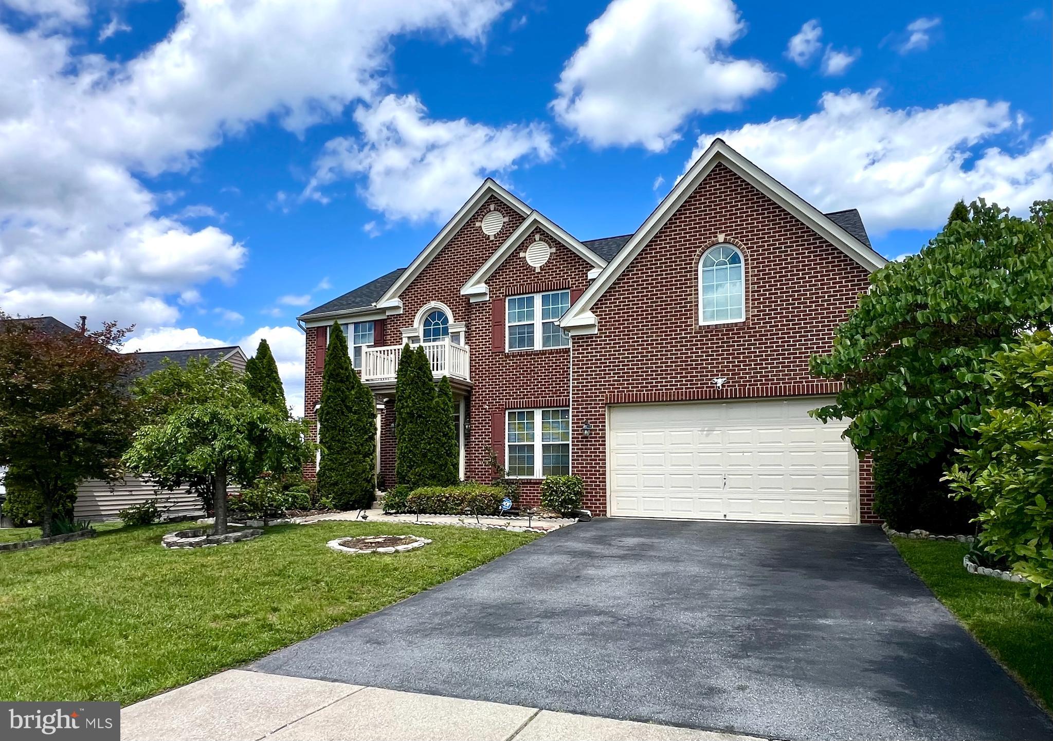 13501 Oaklands Manor Drive Laurel, MD 20708 - Photo 2 of 46 a front view of a house with a yard and garage