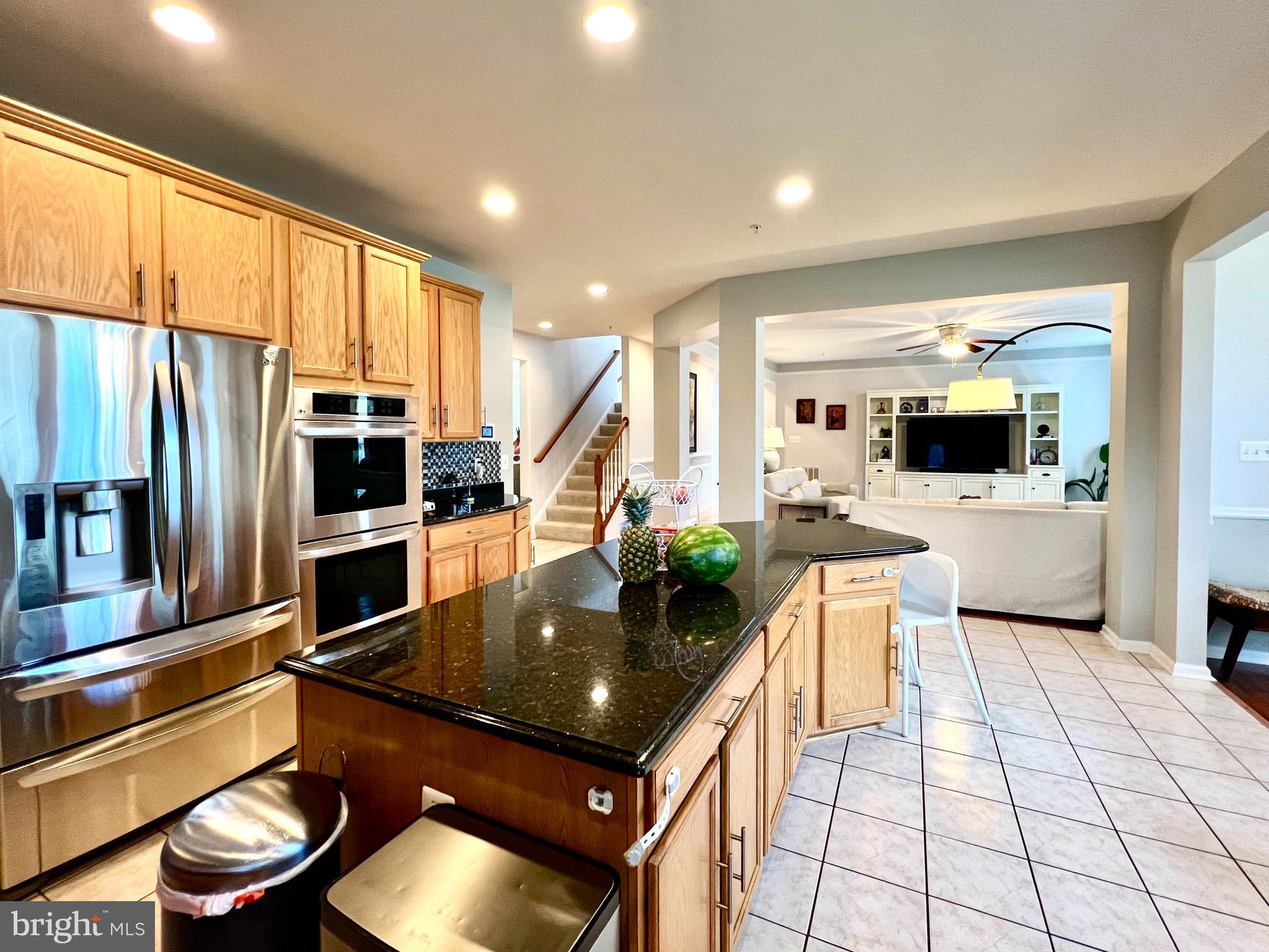 13501 Oaklands Manor Drive Laurel, MD 20708 - Photo 21 of 46 a kitchen with stainless steel appliances granite countertop a sink a stove and a refrigerator