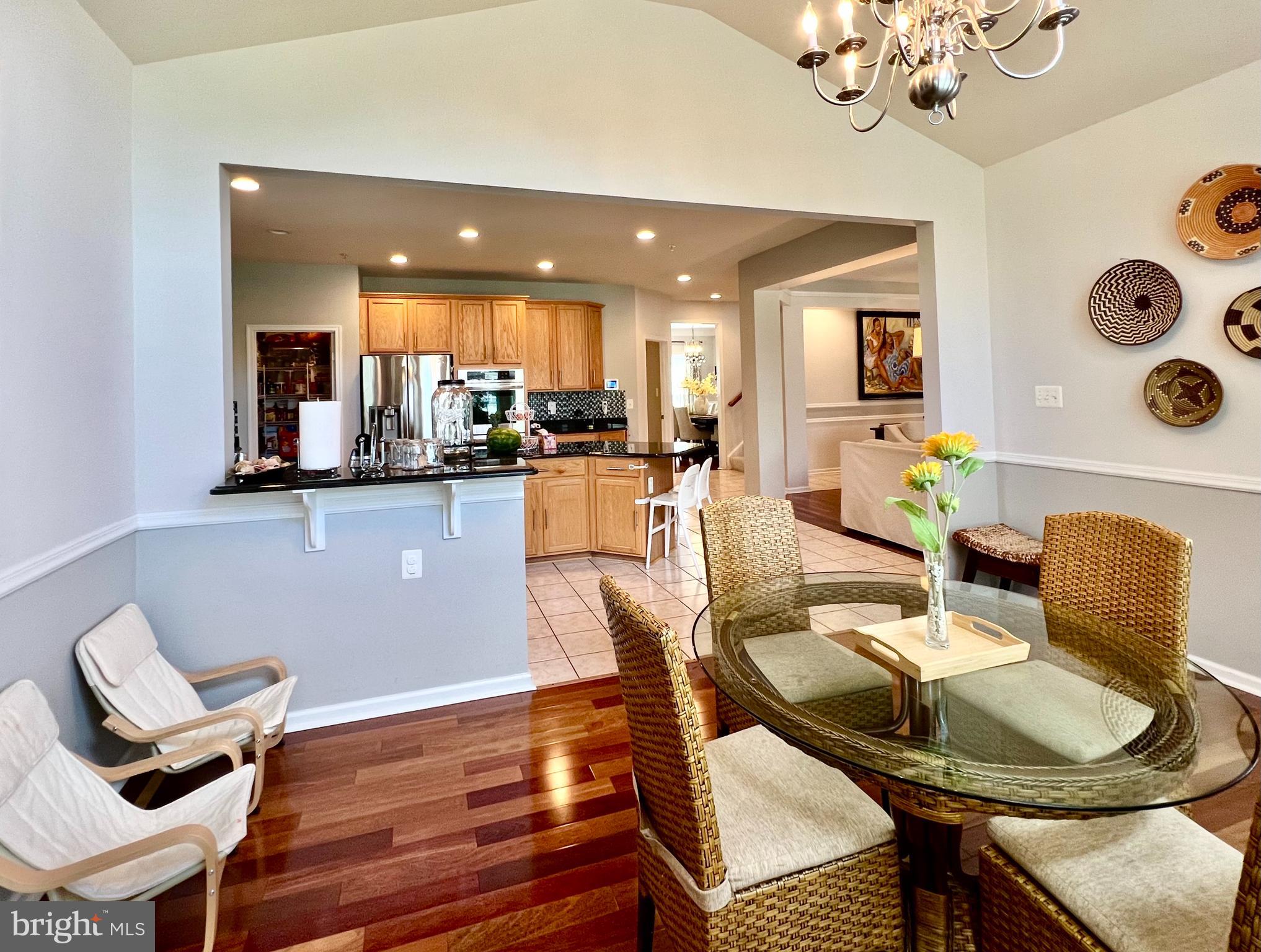 13501 Oaklands Manor Drive Laurel, MD 20708 - Photo 26 of 46 a view of a dining room with furniture and wooden floor
