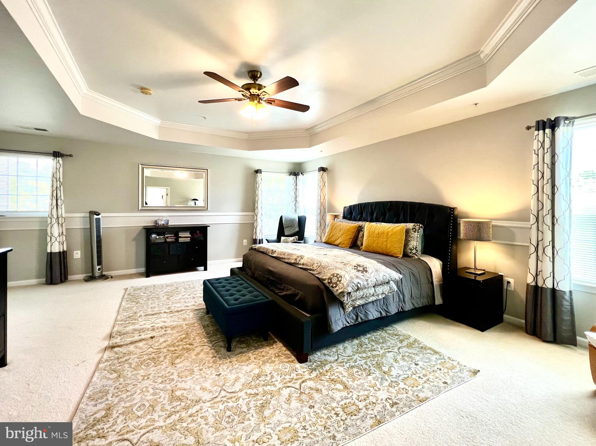 13501 Oaklands Manor Drive Laurel, MD 20708 - Photo 29 of 46 a bedroom with a large bed and a chandelier