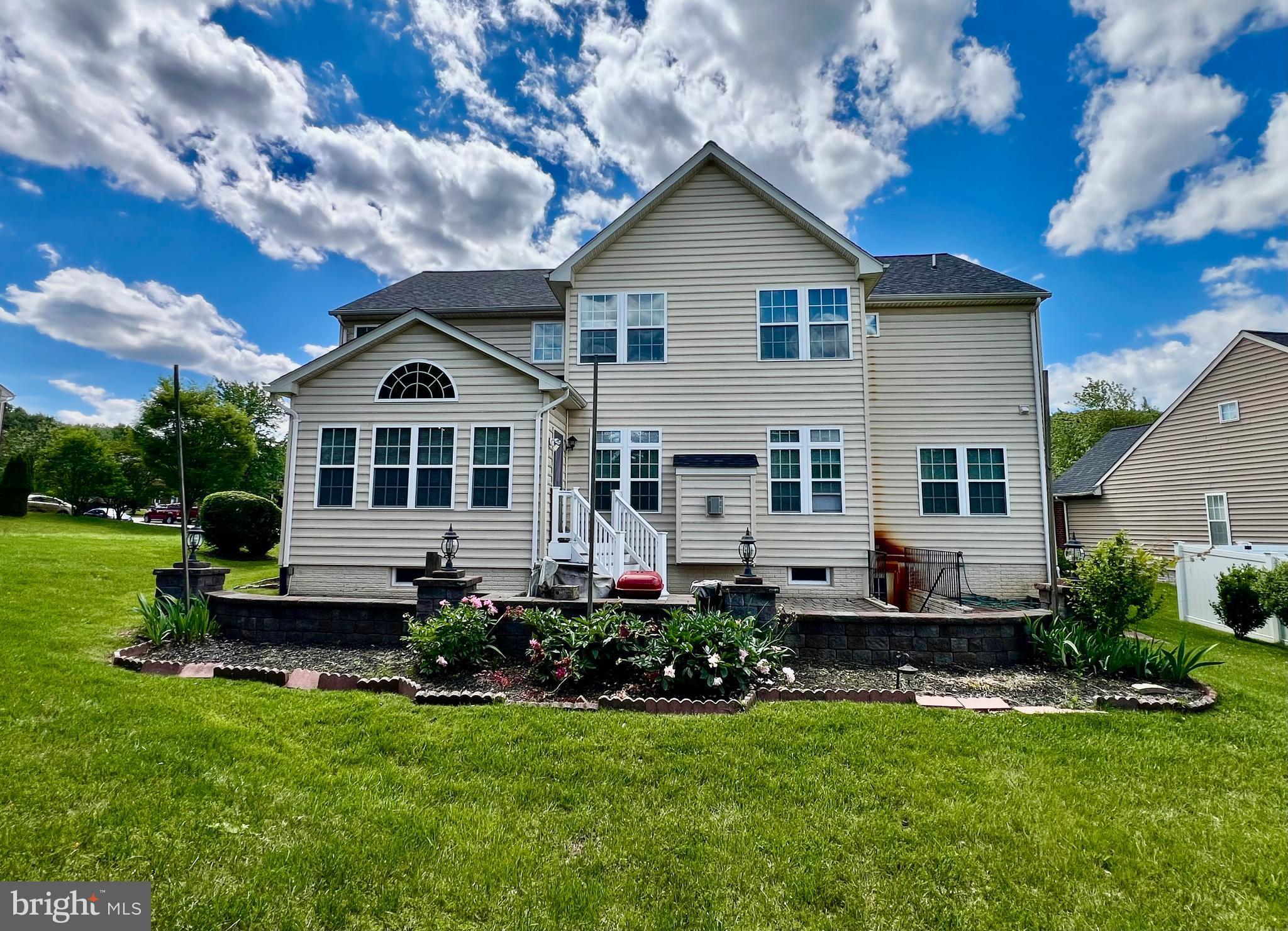13501 Oaklands Manor Drive Laurel, MD 20708 - Photo 3 of 46 a front view of a house with a yard