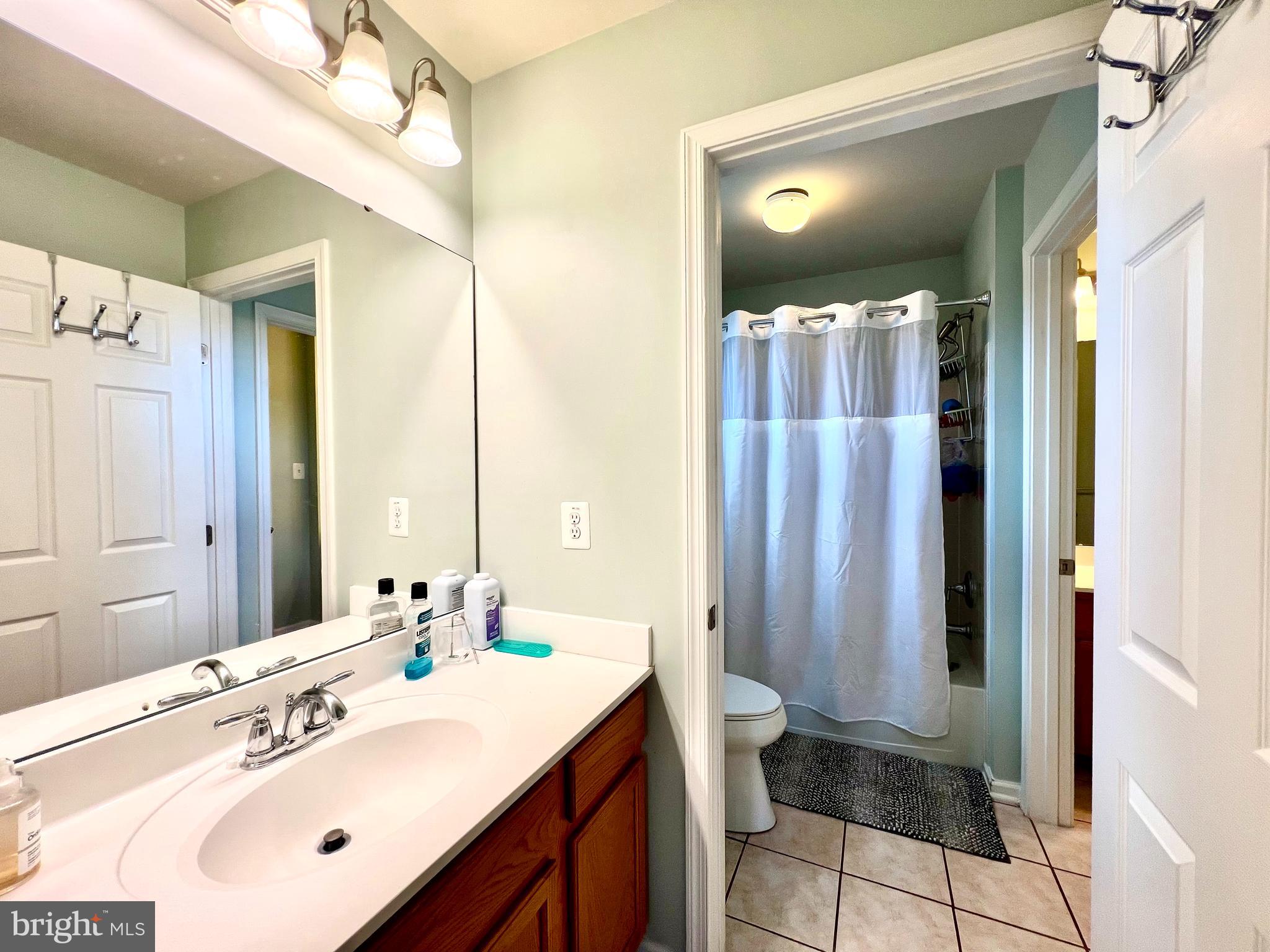 13501 Oaklands Manor Drive Laurel, MD 20708 - Photo 32 of 46 a bathroom with a sink vanity and a mirror