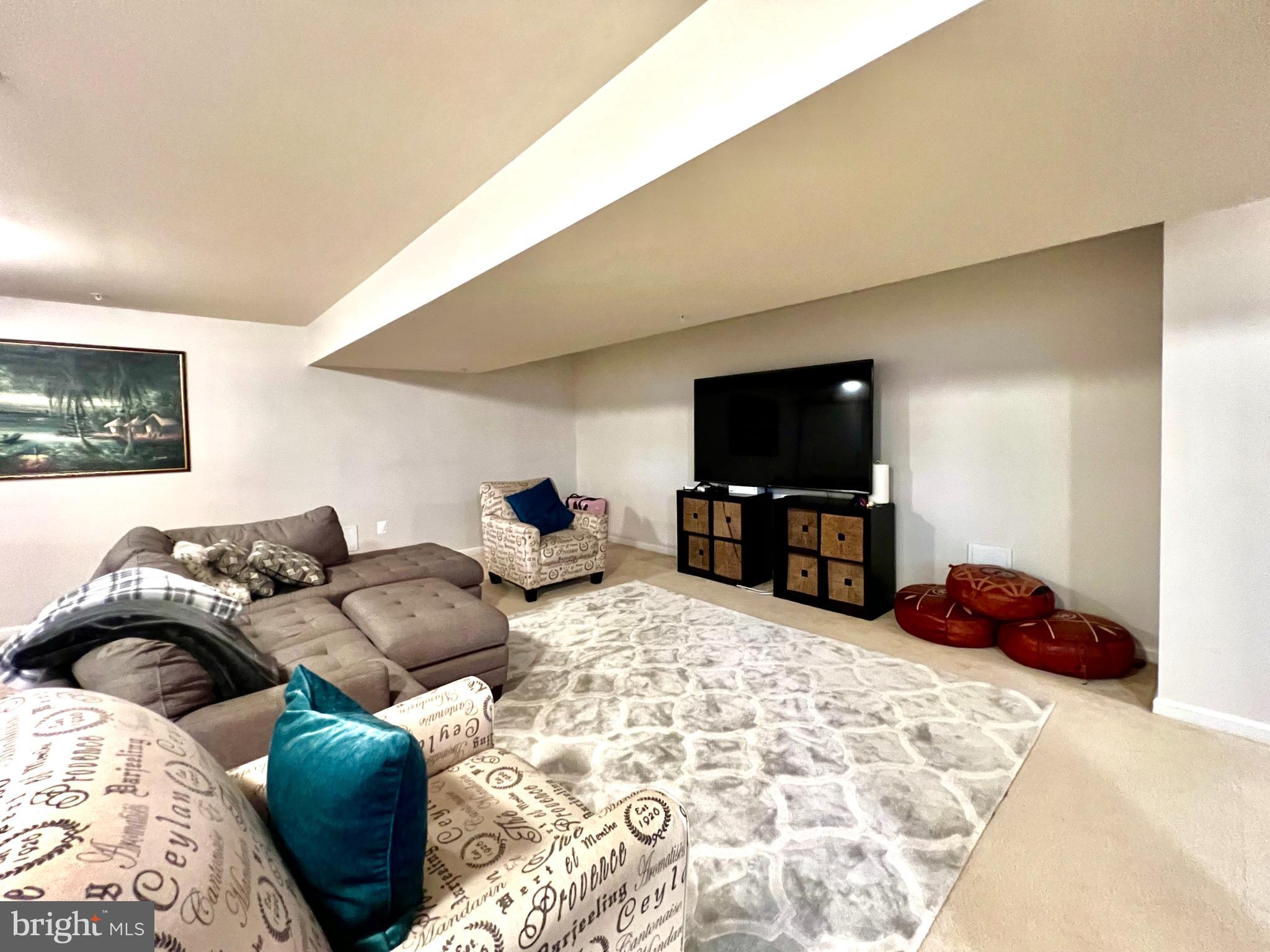 13501 Oaklands Manor Drive Laurel, MD 20708 - Photo 36 of 46 a living room with furniture and a flat screen tv