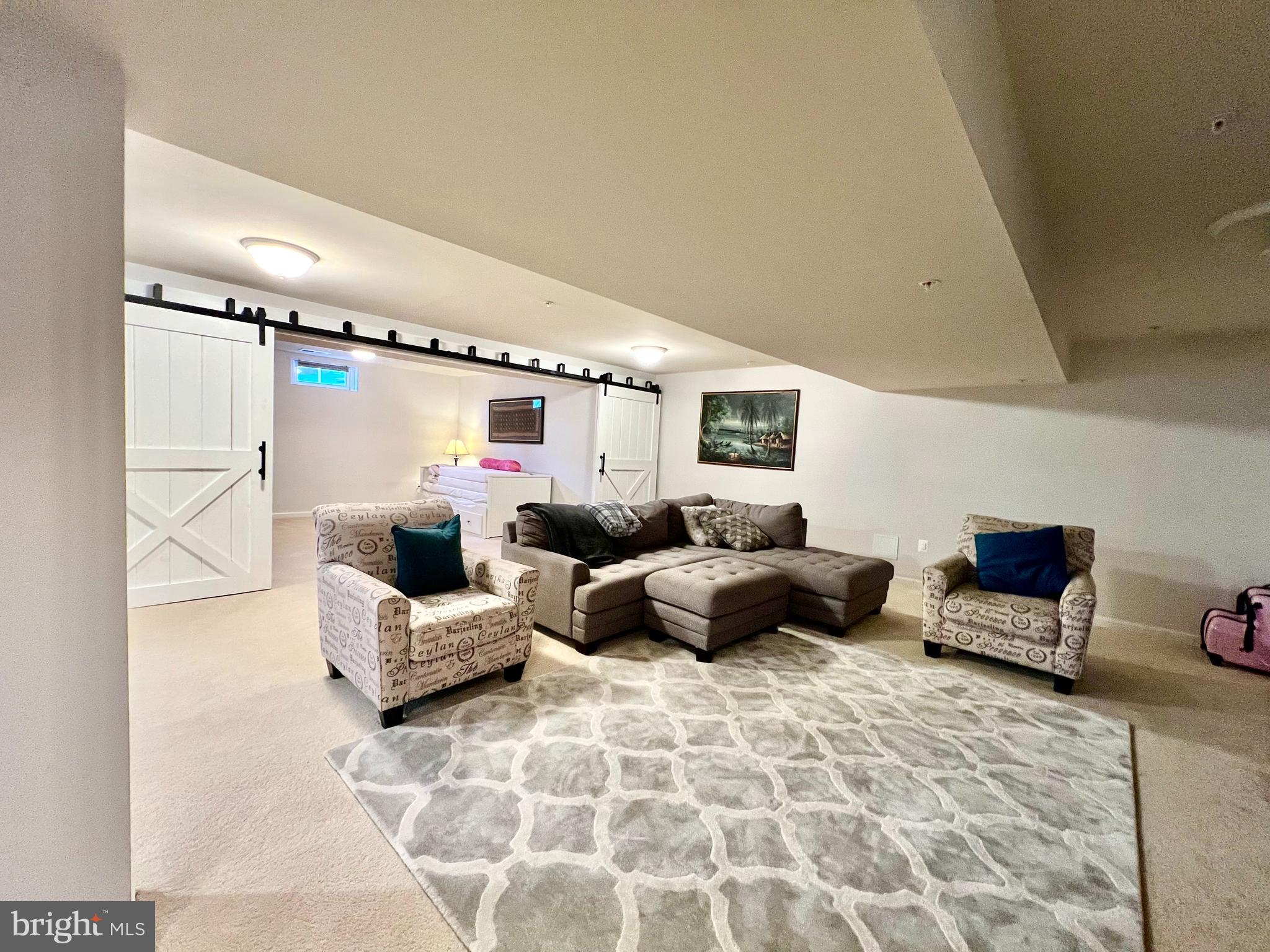 13501 Oaklands Manor Drive Laurel, MD 20708 - Photo 37 of 46 a living room with furniture and a flat screen tv