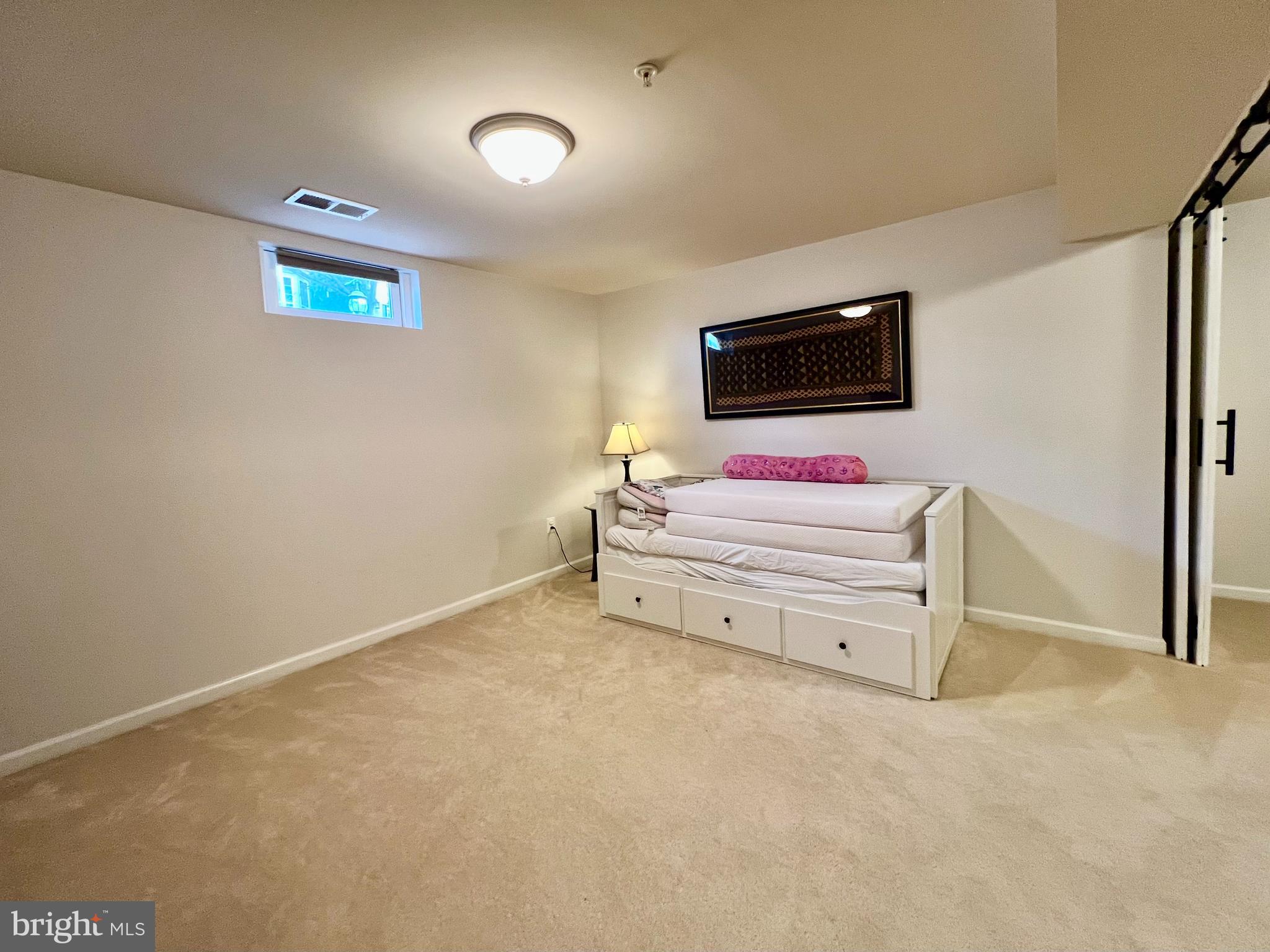 13501 Oaklands Manor Drive Laurel, MD 20708 - Photo 38 of 46 a bedroom with a bed and a flat screen tv