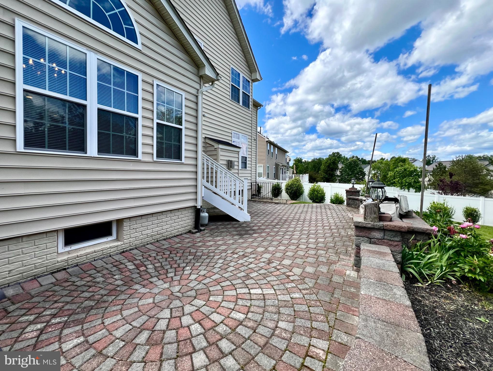 13501 Oaklands Manor Drive Laurel, MD 20708 - Photo 5 of 46 a backyard of a house with barbeque oven and outdoor seating