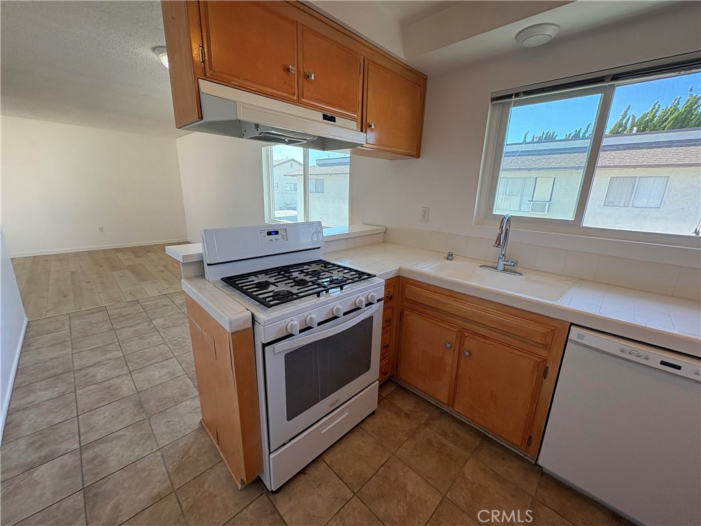 17061 Evergreen Circle, Unit D Huntington Beach, CA 92647 - Photo 3 of 18 a kitchen with a stove cabinets and a sink