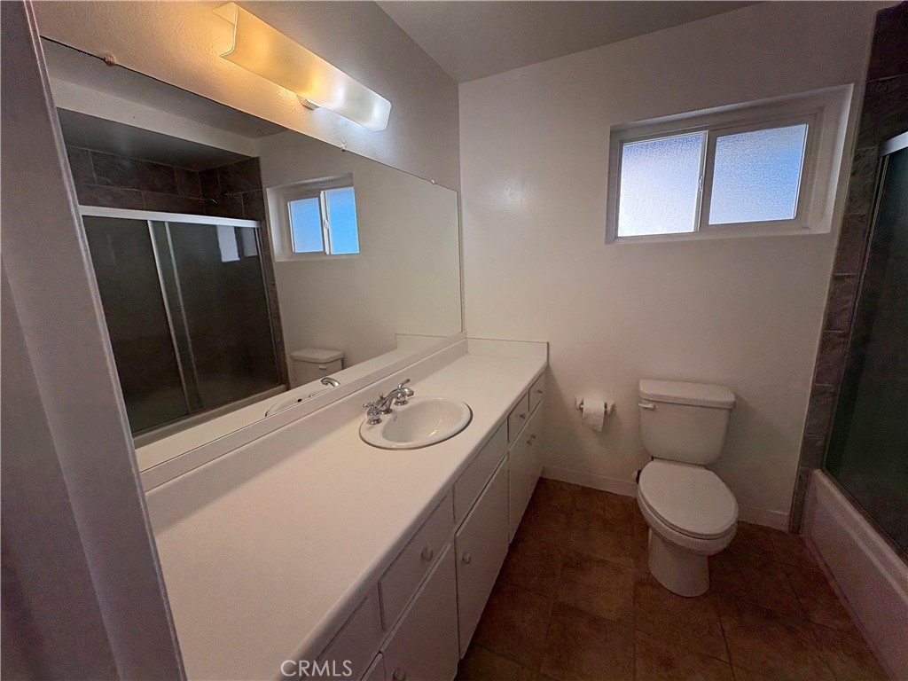 17061 Evergreen Circle, Unit D Huntington Beach, CA 92647 - Photo 8 of 18 a bathroom with a sink a toilet and mirror