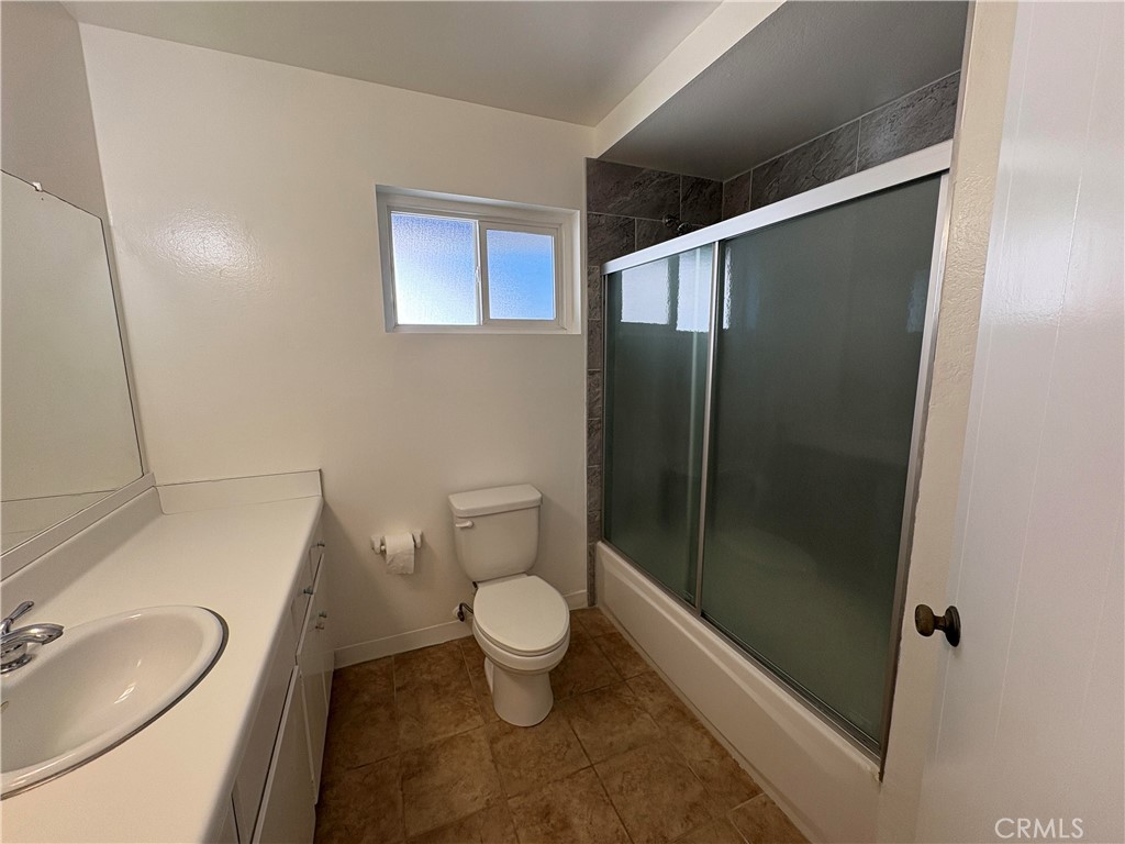 17061 Evergreen Circle, Unit D Huntington Beach, CA 92647 - Photo 9 of 18 a bathroom with a toilet and a shower