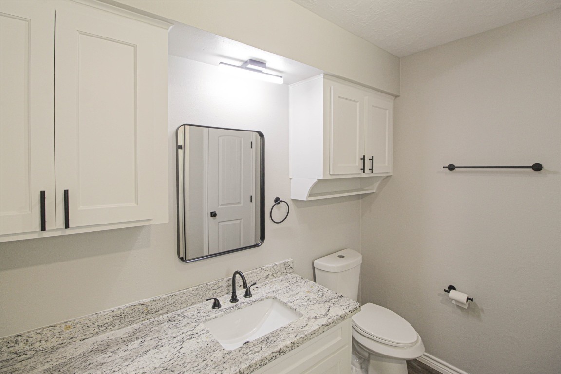 115 Corry Jones Livingston, TX 77351 - Photo 16 of 31 a bathroom with a granite countertop sink toilet and shower