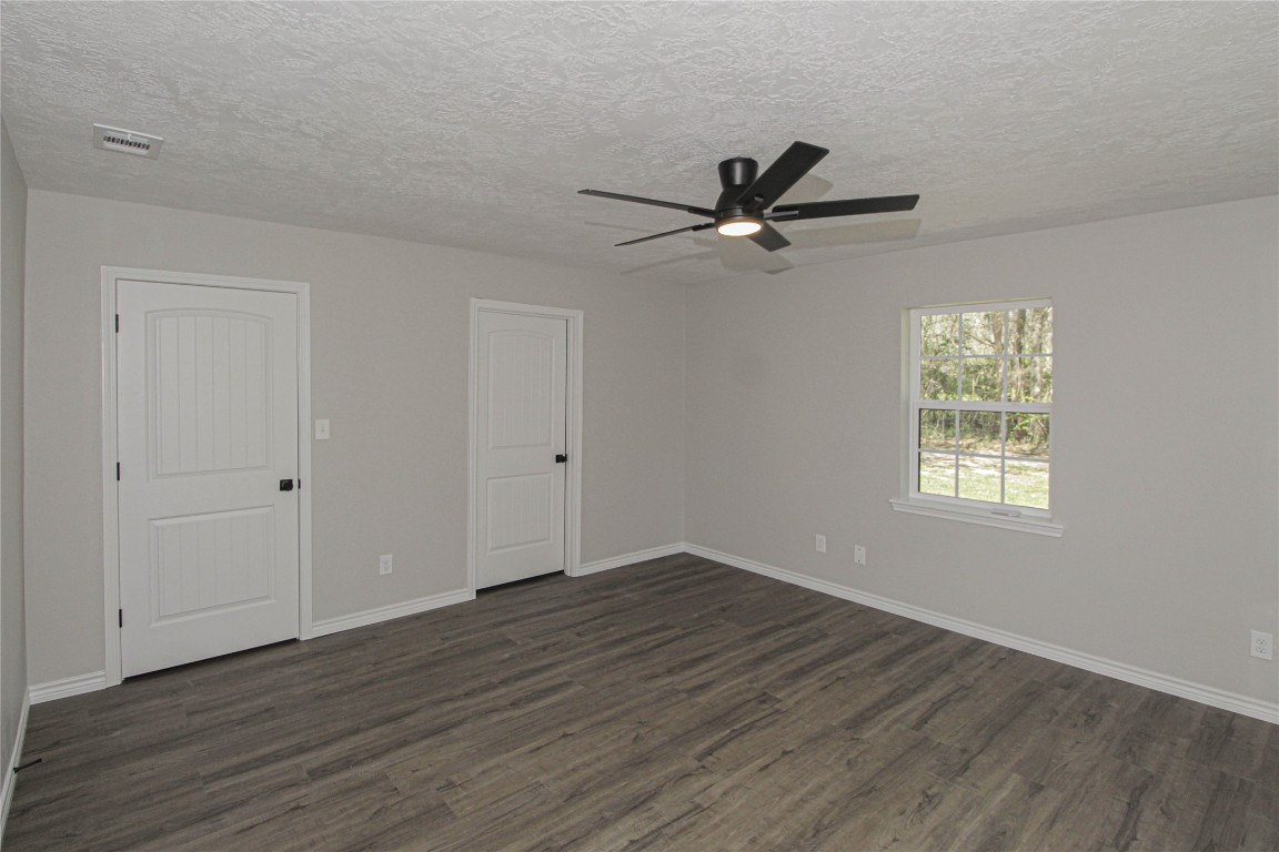 115 Corry Jones Livingston, TX 77351 - Photo 19 of 31 a view of an empty room with a window and wooden floor