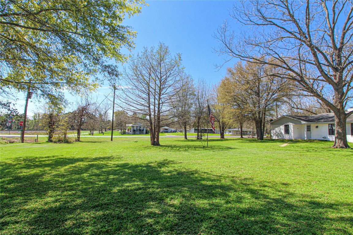 115 Corry Jones Livingston, TX 77351 - Photo 2 of 31 a view of a grassy field with trees