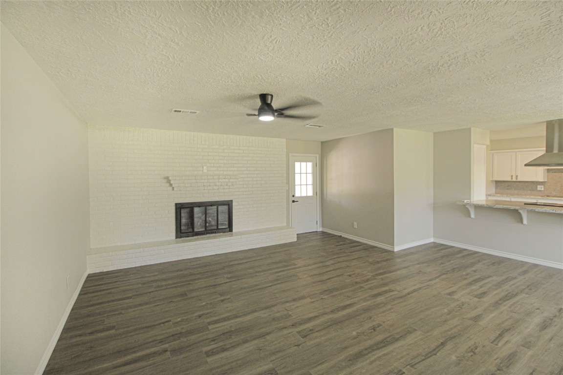 115 Corry Jones Livingston, TX 77351 - Photo 22 of 31 a view of an empty room with a fireplace and a window