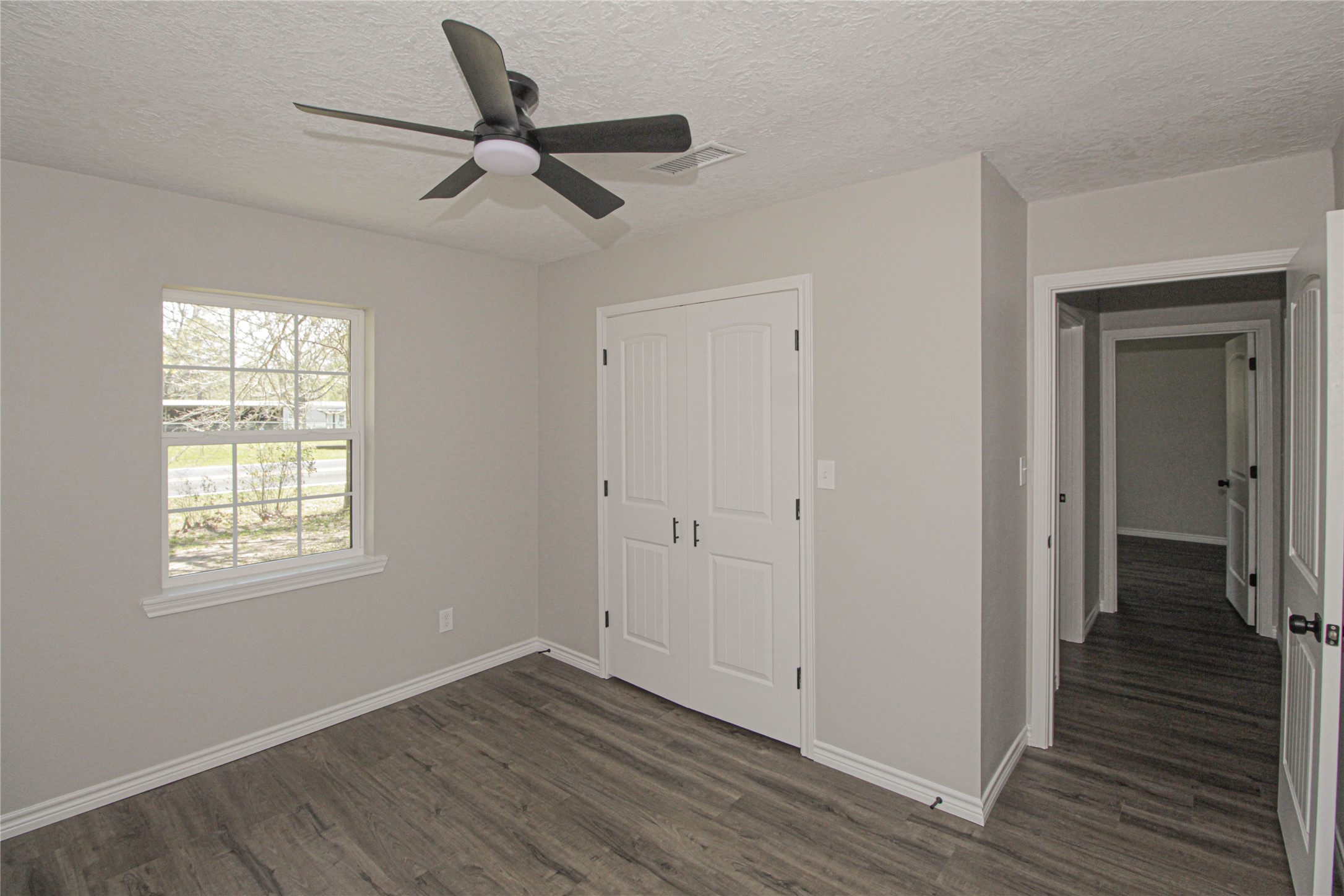 115 Corry Jones Livingston, TX 77351 - Photo 27 of 31 a view of an empty room with wooden floor and a window