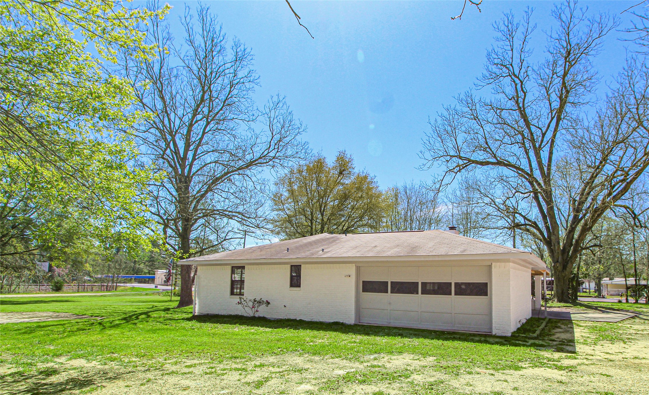 115 Corry Jones Livingston, TX 77351 - Photo 4 of 31 a view of a white house with a big yard and large trees