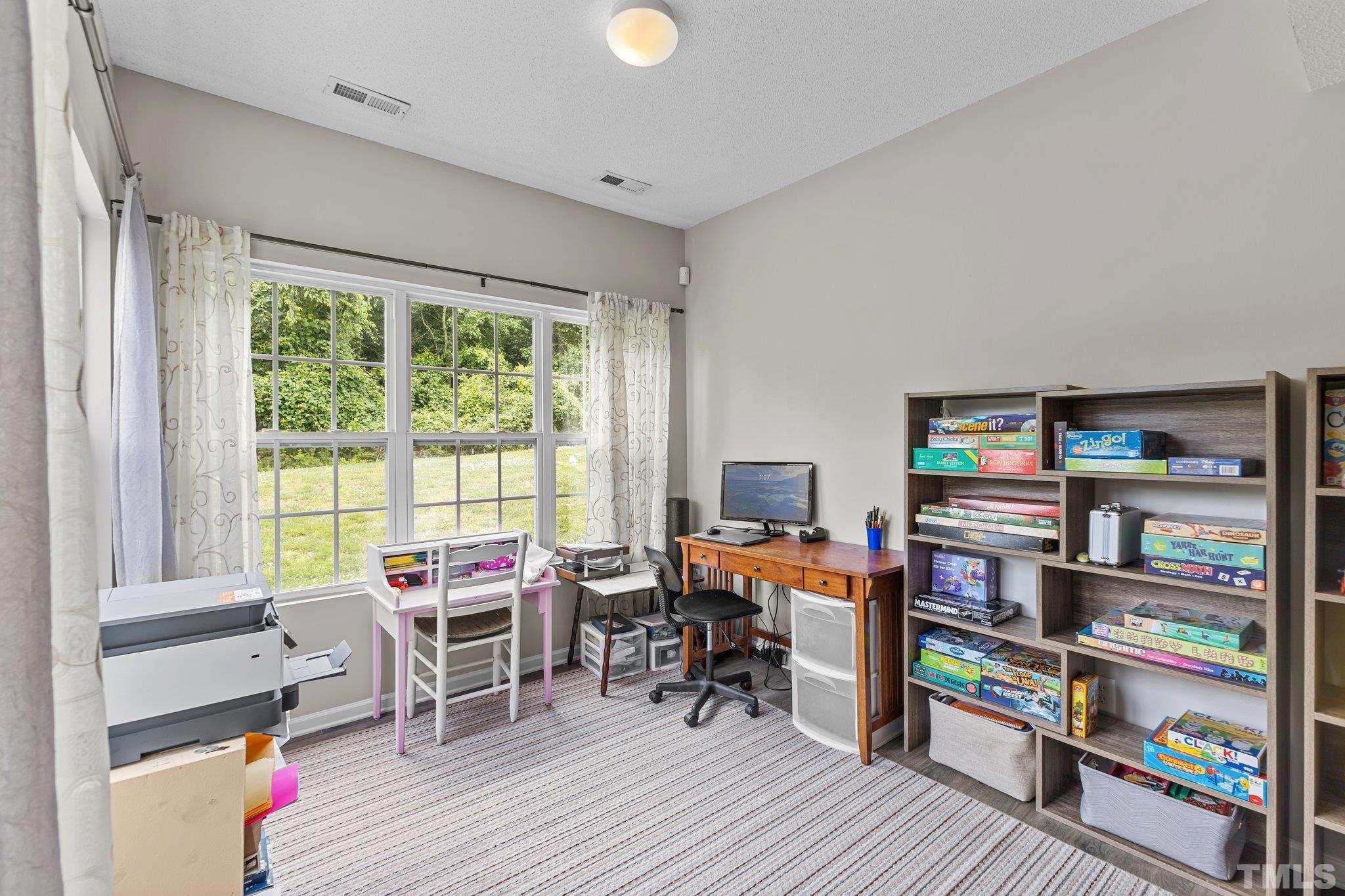 3366 Bridgeville Road Raleigh, NC 27610 - Photo 13 of 37 a reading room with furniture wooden floor and a book shelf