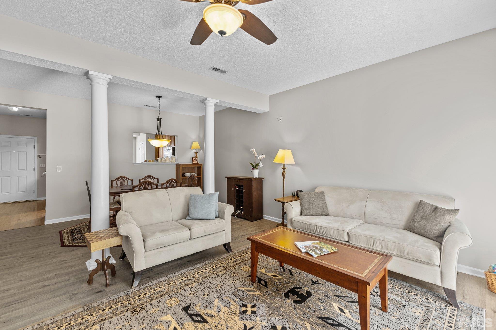 3366 Bridgeville Road Raleigh, NC 27610 - Photo 16 of 37 a living room with furniture and a wooden floor