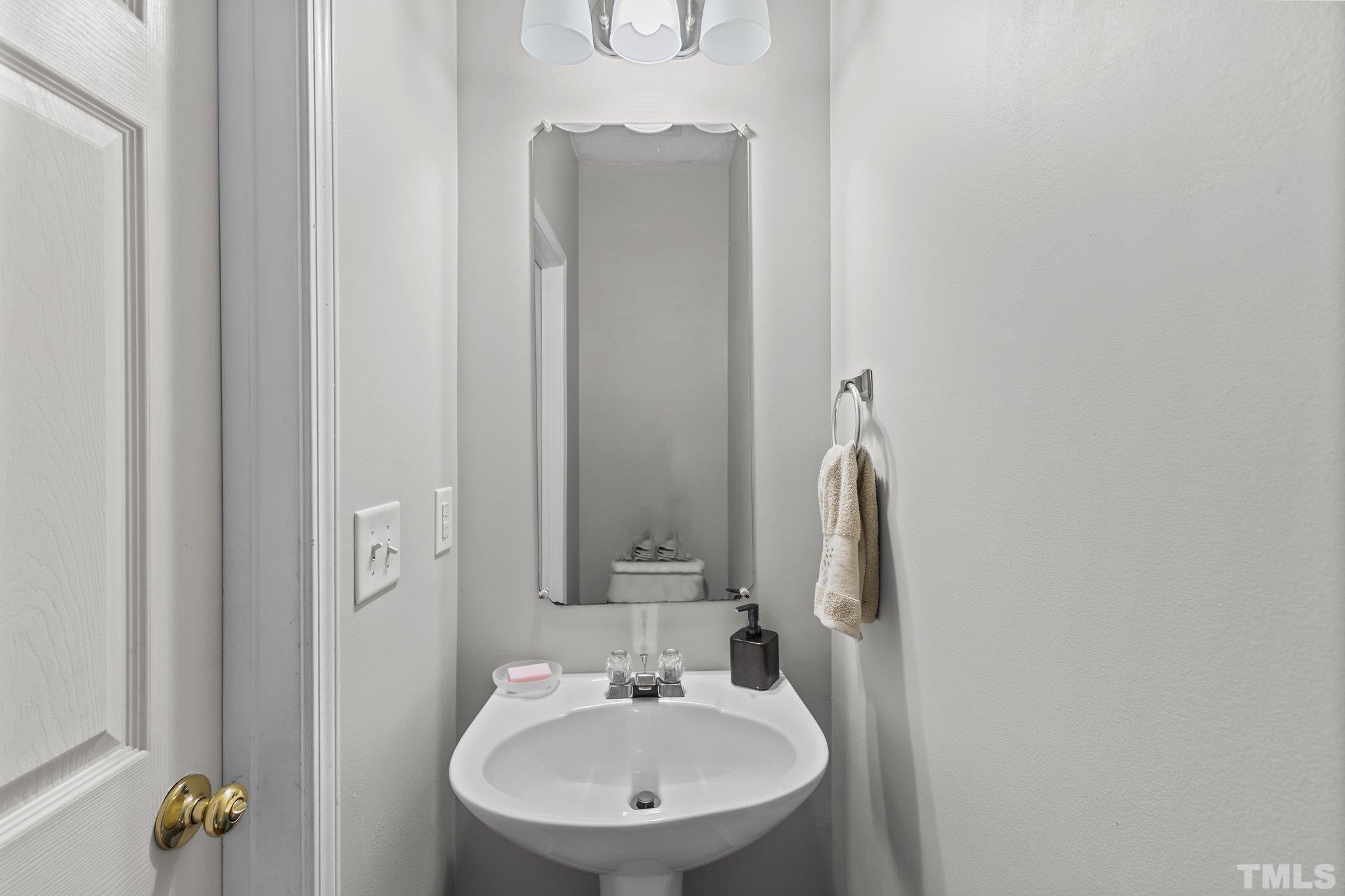3366 Bridgeville Road Raleigh, NC 27610 - Photo 18 of 37 a bathroom with a sink and a mirror