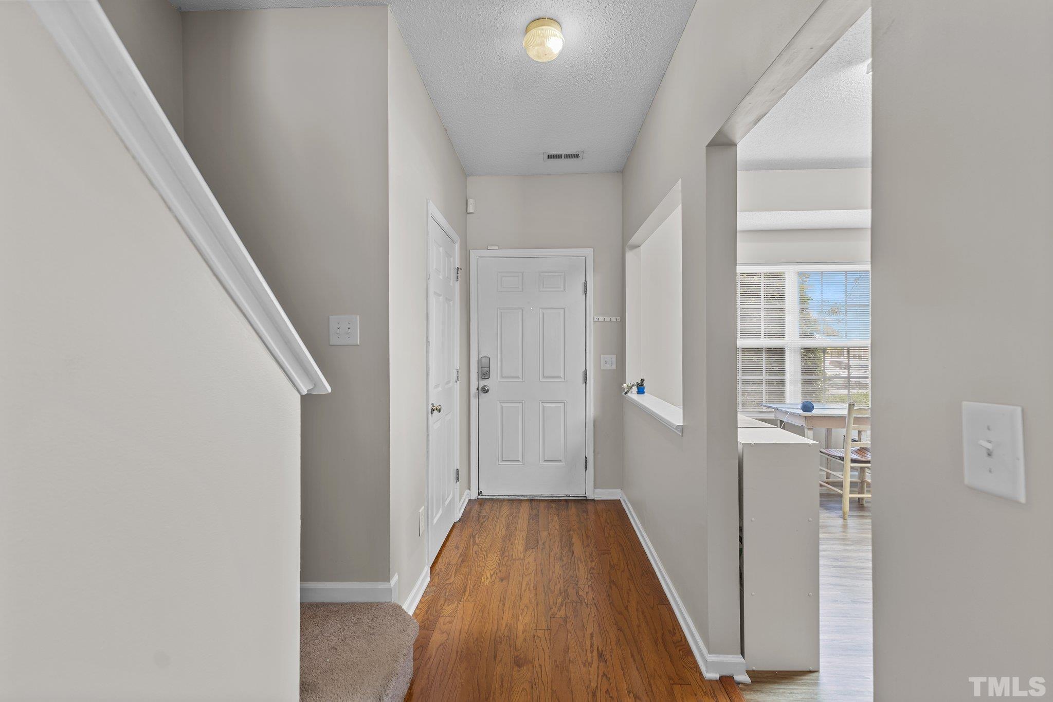 3366 Bridgeville Road Raleigh, NC 27610 - Photo 20 of 37 a view of a hallway with wooden floor and staircase