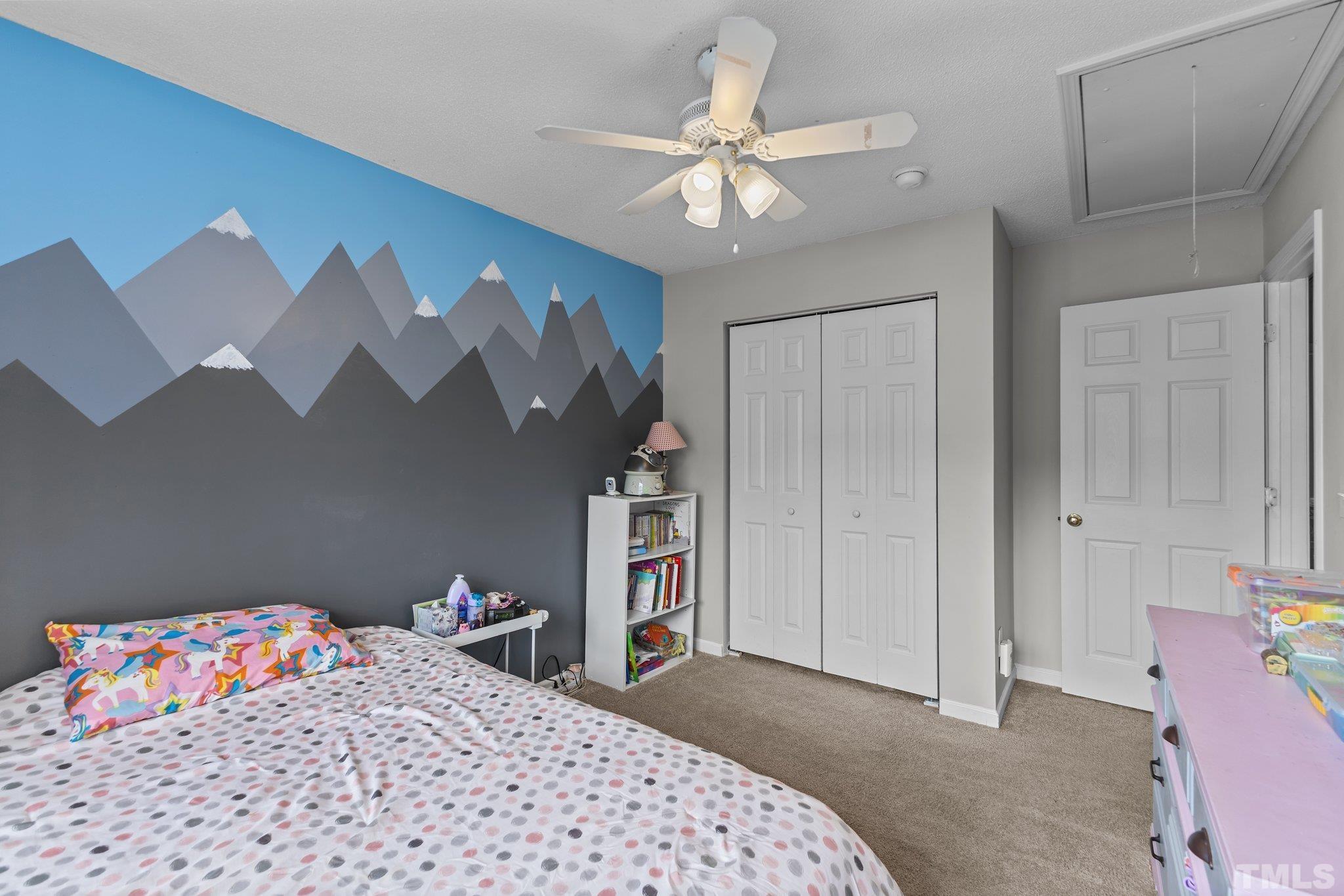 3366 Bridgeville Road Raleigh, NC 27610 - Photo 25 of 37 a bedroom with a bed and a chandelier